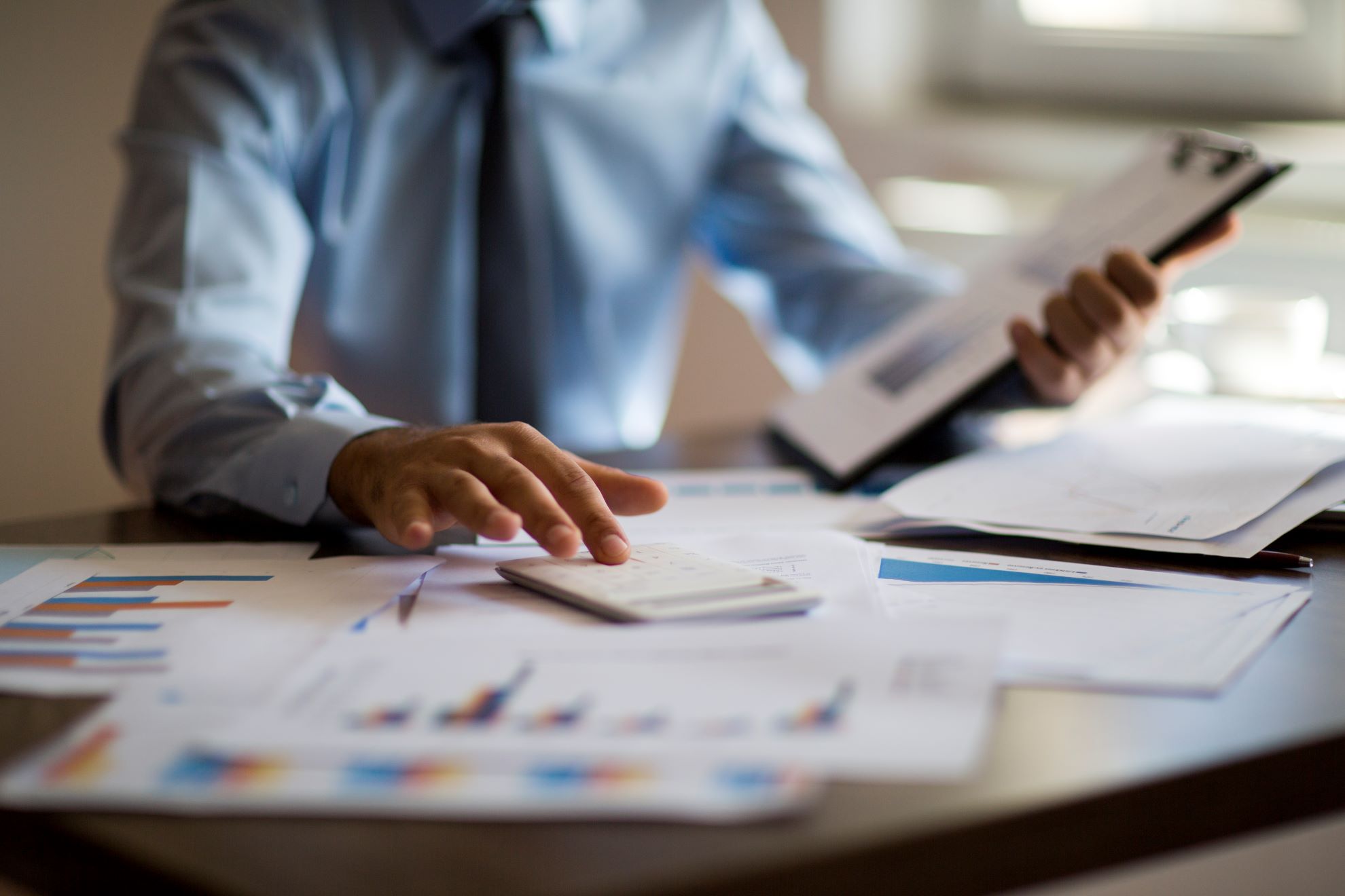 Business man points to data files 